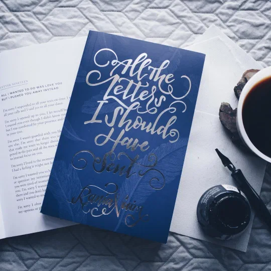 A navy hardcover book with its title foil-stamped in silver